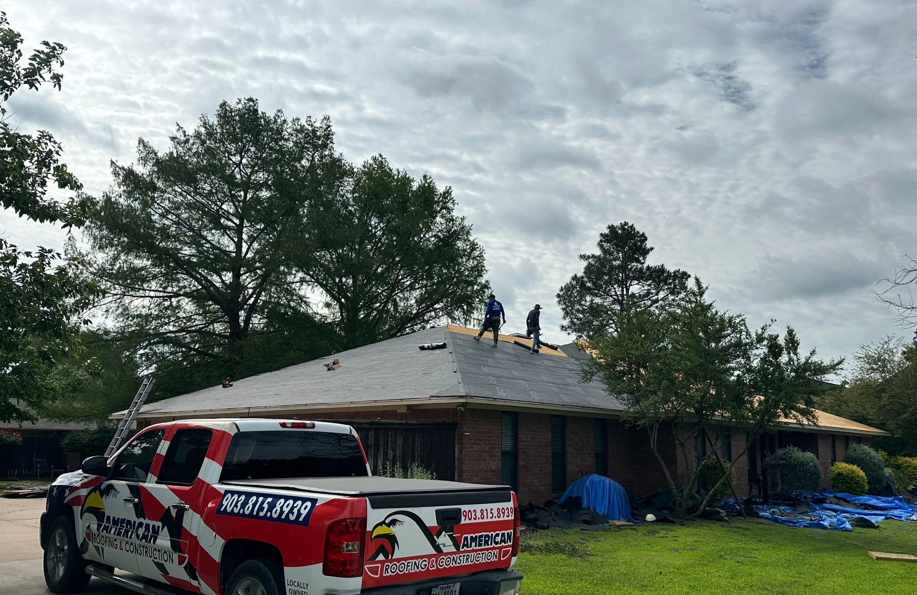 American Roofing & Construction crew working on a roof
