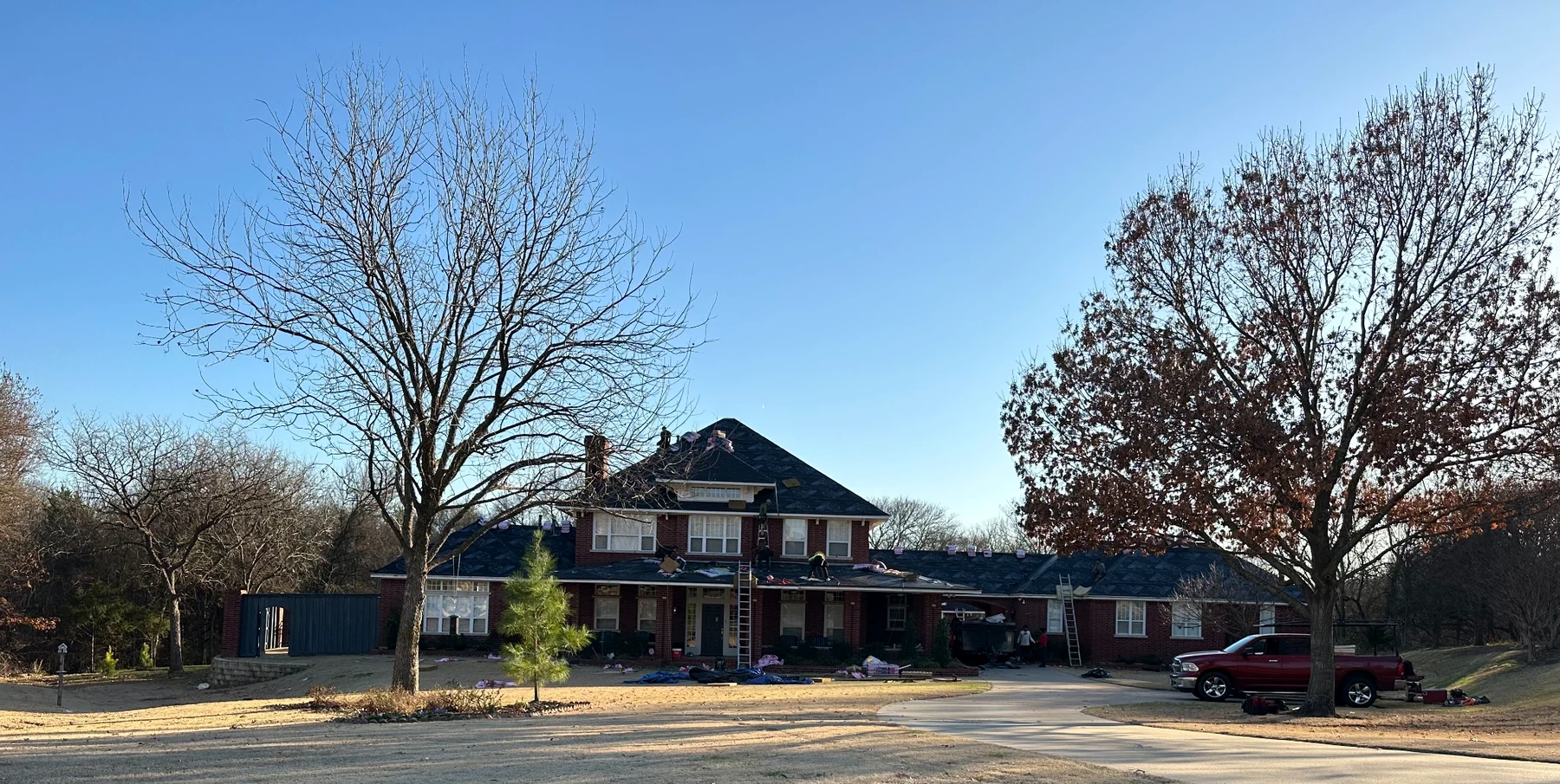 Large residential roof replacement by American Roofing & Construction